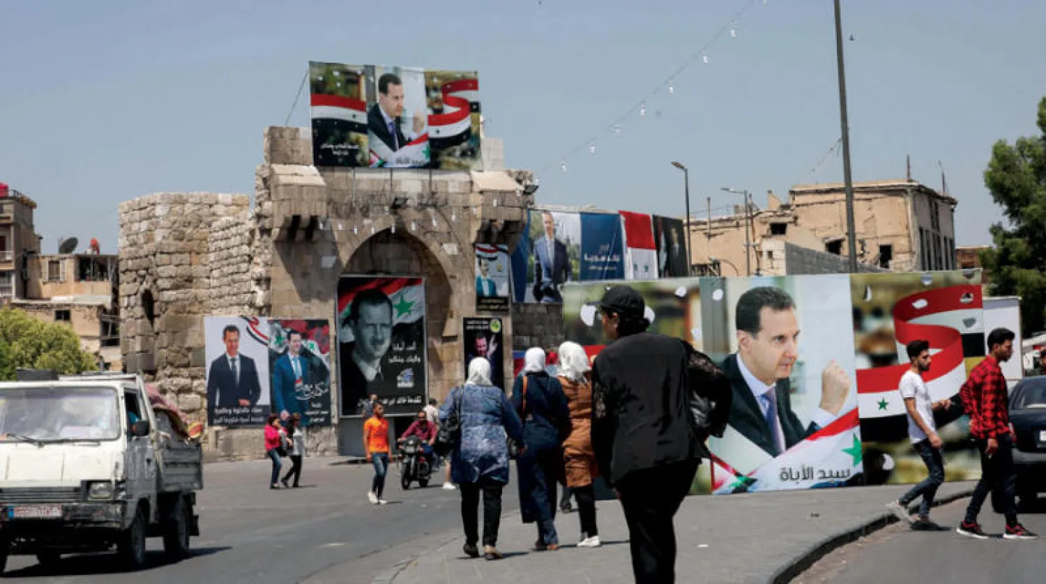 صور بشار الأسد قبل إزالتها من شوارع دمشق (أرشيفية)