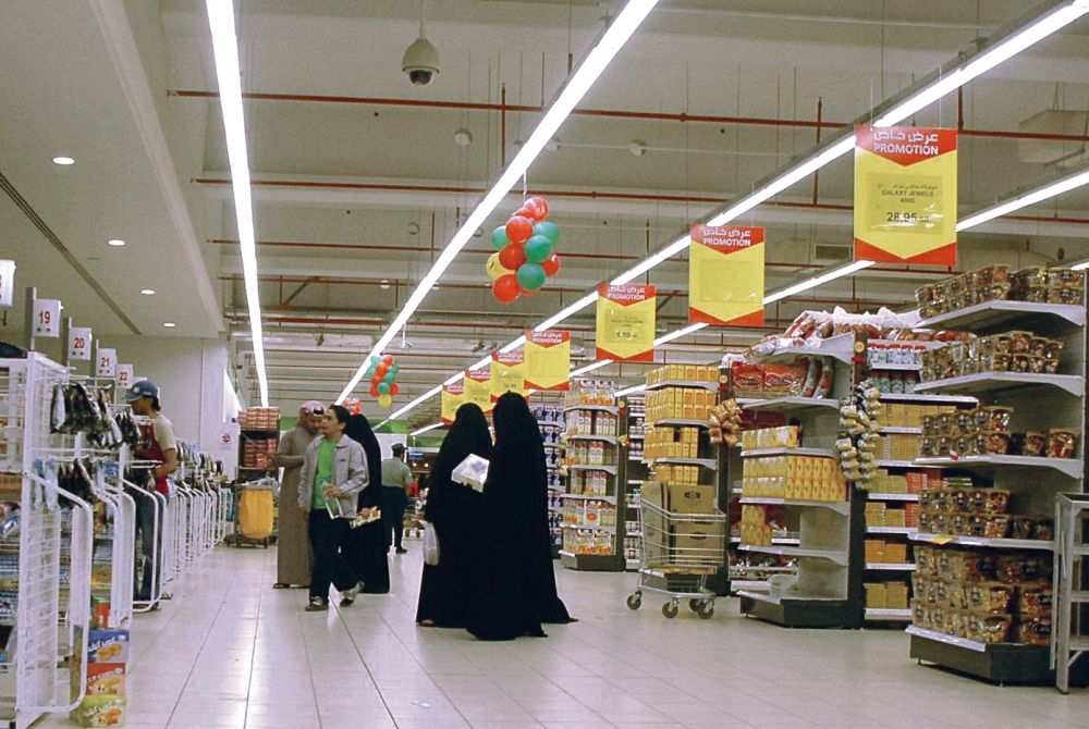 سعوديون يتبضعون من إحدى المتاجر (وكالات)