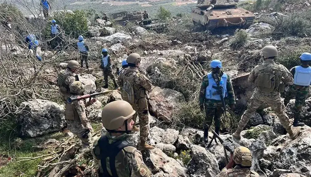 عناصر من الجيش اللبناني بمواجهة الجيش الإسرائيلي يفصل بينهما اليونيفيل على الحدود