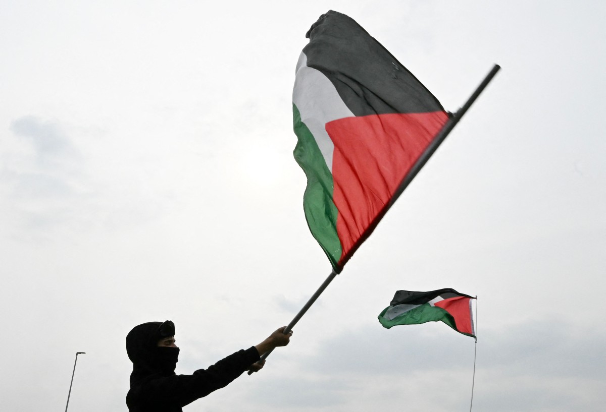 متظاهر مؤيد للفلسطينيين يلوح بعلم فلسطيني خلال مظاهرة على الطريق السريع في ميلانو احتجاجاً على اعتراض الجيش الإسرائيلي لأسطول الصمود العالمي (أ ف ب)