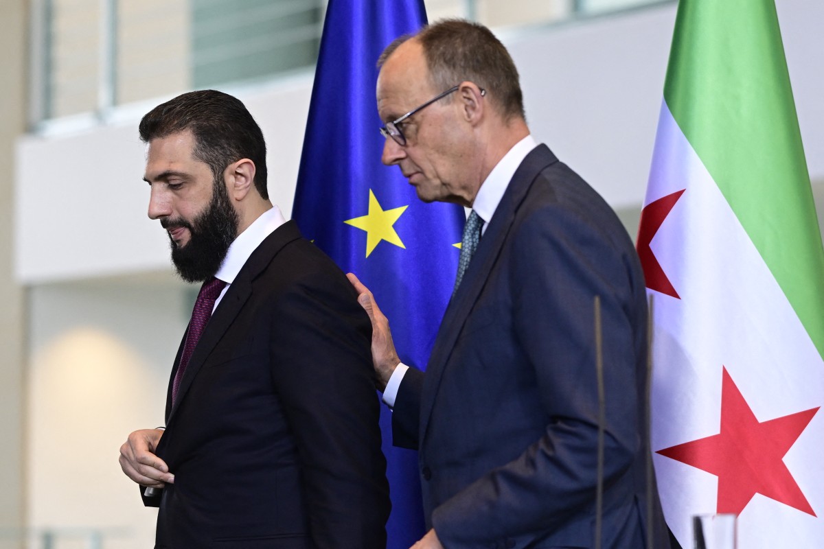 أحمد الشرع وفريدريش ميرتس (أ ف ب).