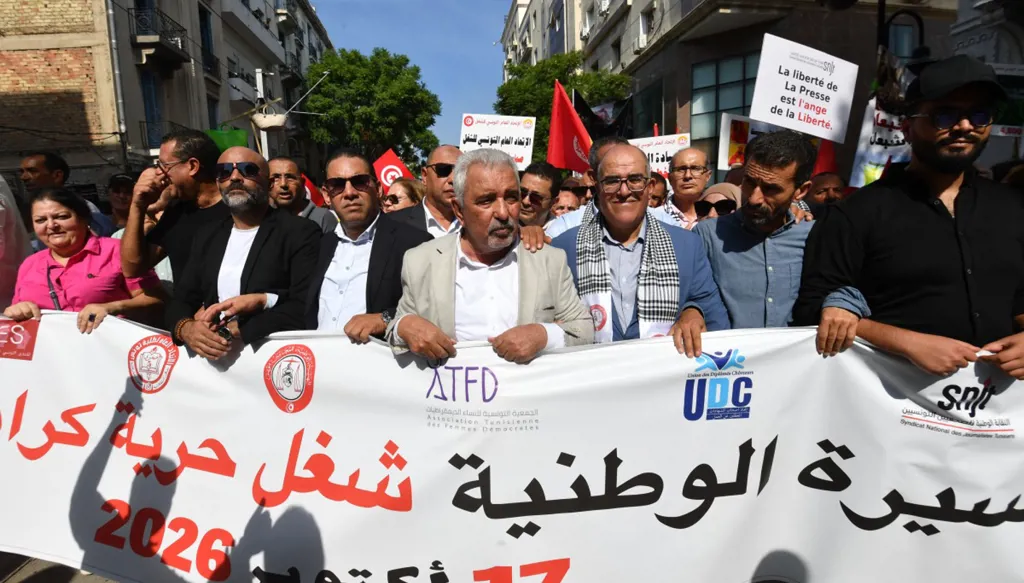 الأمين العام للاتحاد العام التونسي للشغل صلاح الدين السالمي (وسط الصورة) يشارك في مسيرة احتجاجية ضد الرئيس قيس سعيّد في العاصمة تونس، 17 تشرين الأول/أكتوبر 2026. (أ ف ب)