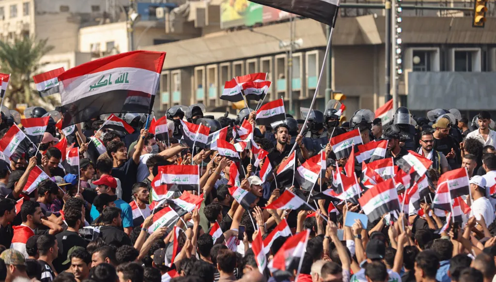 متظاهرون يرفعون الأعلام العراقية ويهتفون بشعارات خلال إحياء الذكرى السابعة لاحتجاجات تشرين في ساحة التحرير ببغداد، 25 تشرين الأول/أكتوبر 2026. (أ ف ب)