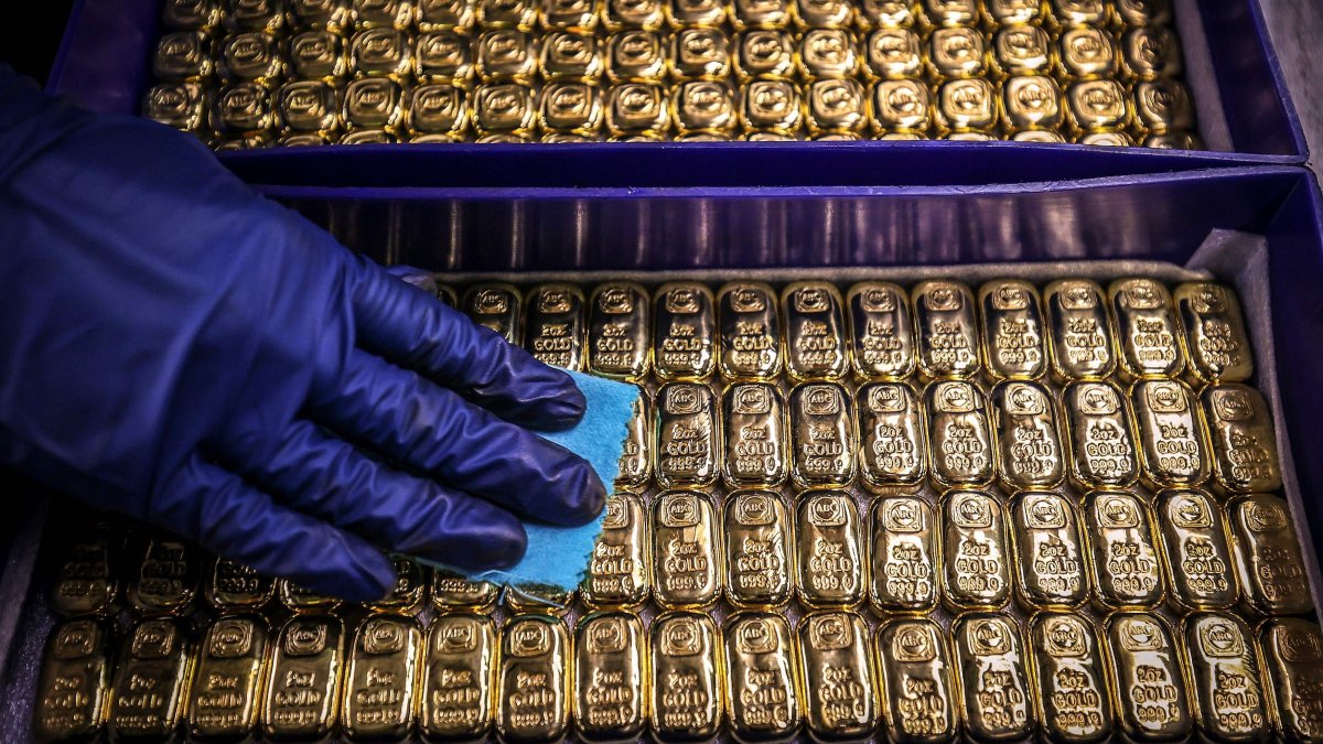 A worker polishes gold bars at a factory in Sydney. (AFP)