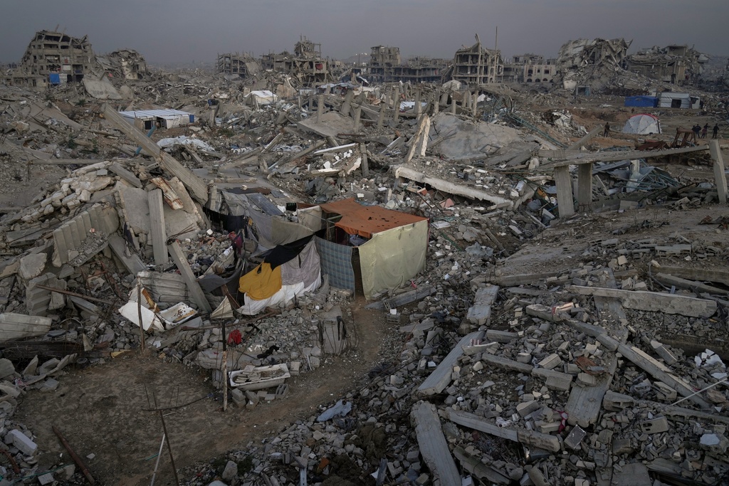 A tent belonging to the Magdi Arafat family stands among the ruins of homes in the Al-Zaytoun neighborhood of Gaza City, Friday, Nov. 27, 2025. (AP Photo/Jehad Alshrafi)
