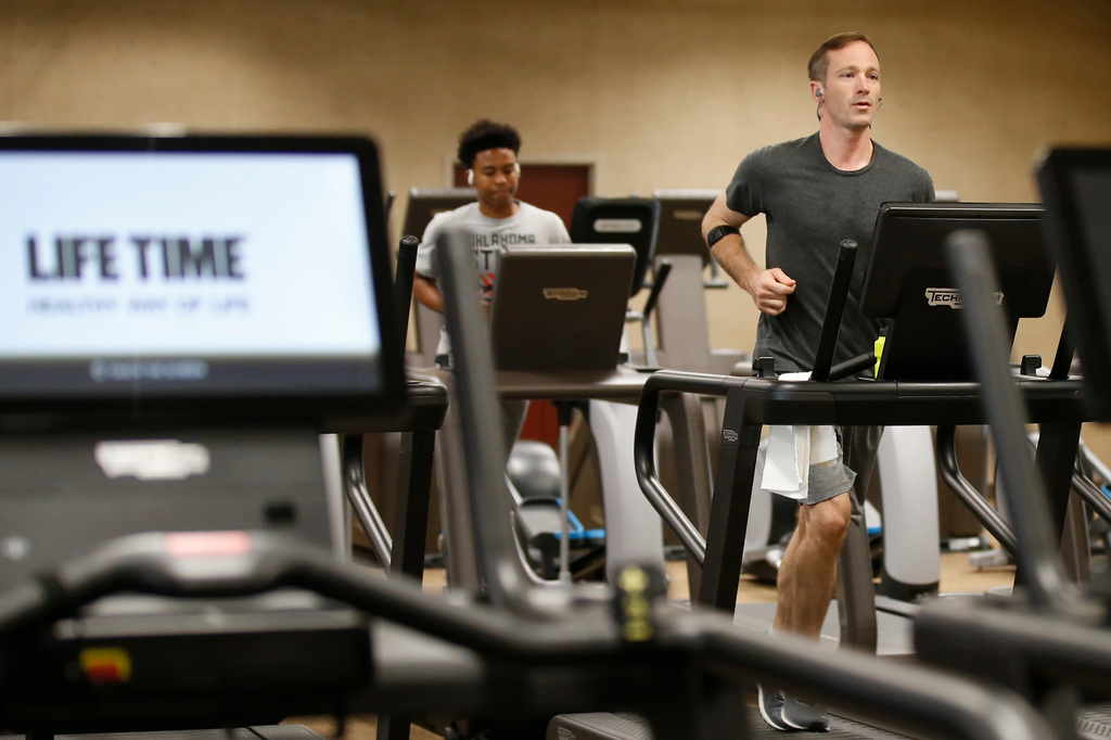 People run on treadmills at Life Time Athletic May 8, 2020, in Oklahoma City. (AP Photo/Sue Ogrocki, File)