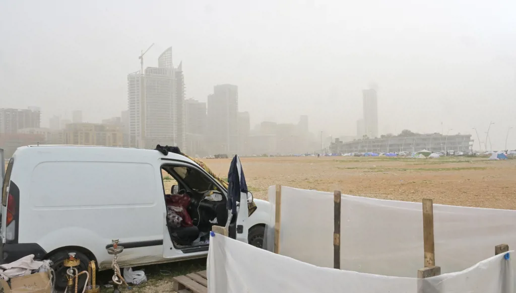 A displaced person has turned his car into a home and shelter.