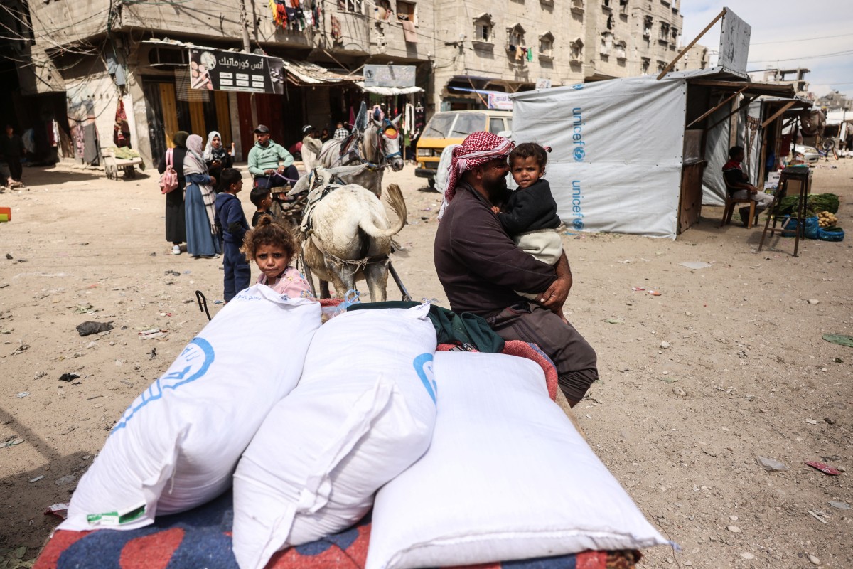 فلسطينيون نازحون يتسوقون لشراء الطعام في سوق مفتوح في خان يونس، جنوب قطاع غزة، في 25 آذار/مارس 2026 (أ ف ب)