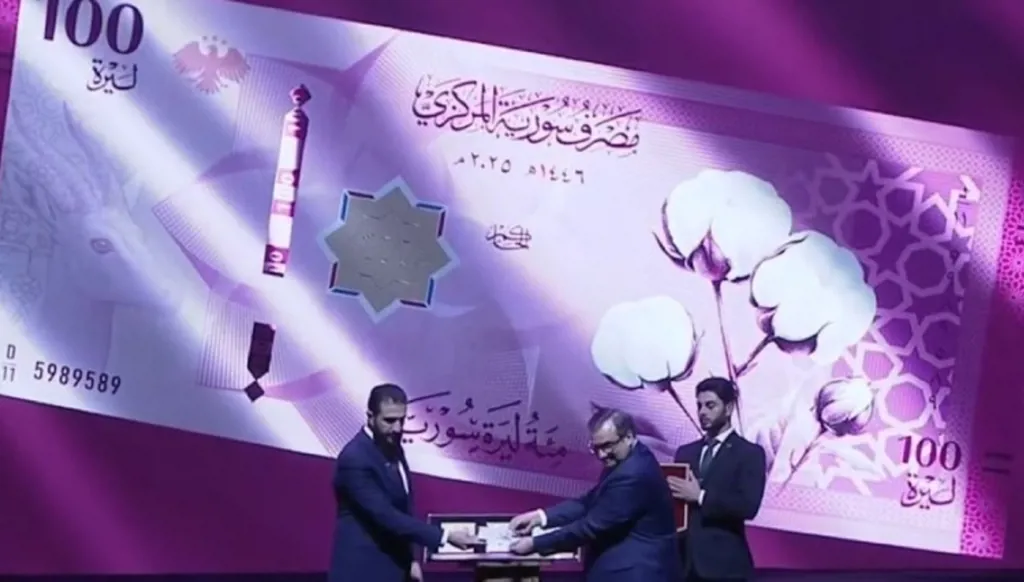 Syria unveils new currency as president urges calm during transition