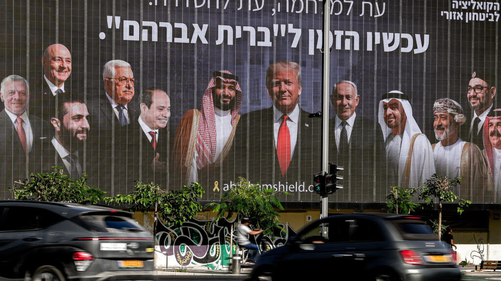 لوحة إعلانية في تل أبيب تروج لاتفاقيات إبراهيم، ويظهر فيها الشرع. 26 يونيو 2025. (أ ف ب)