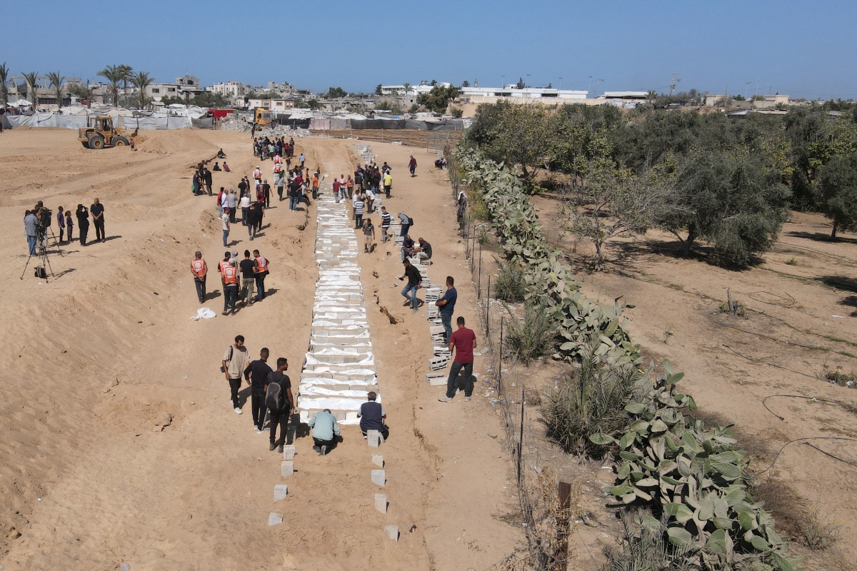 فلسطينيون يدفنون جثث مجهولة الهوية في مقبرة بدير البلح ‏وسط غزة (أ ف ب)‏