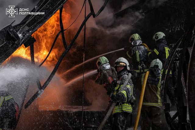 رجال إطفاء أوكرانيون يعملون في موقع استهداف منشأة للبنية التحتية للطاقة خلال غارات صاروخية وطائرات مسيرة روسية ليلية، في خضم الهجوم الروسي على أوكرانيا، في منطقة بولتافا، أوكرانيا، 16 تشرين الأول/أكتوبر 2025 (رويترز)