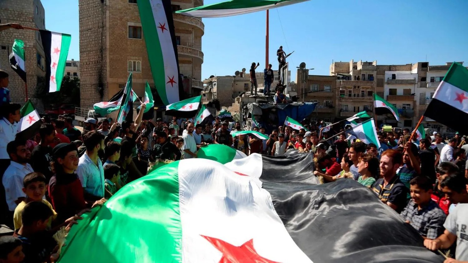 Syrian protesters, attend an anti-government demonstration in northern Syrian city of Idlib. (AFP)