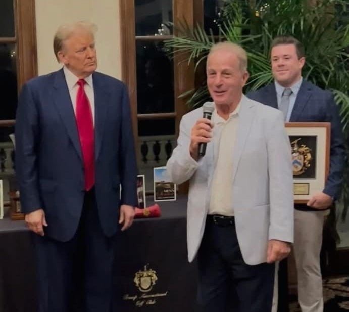 ميشال عيسى إلى جانب ترامب (وكالات).