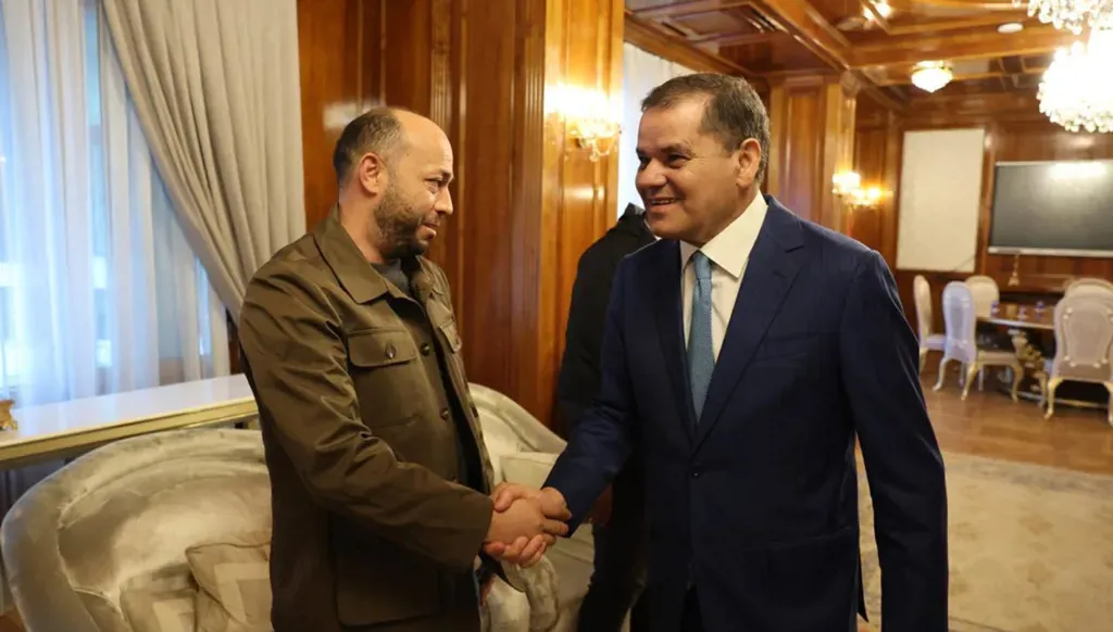 A human Smuggler in the presence of Libya's Prime Minister… What lies behind this alliance?