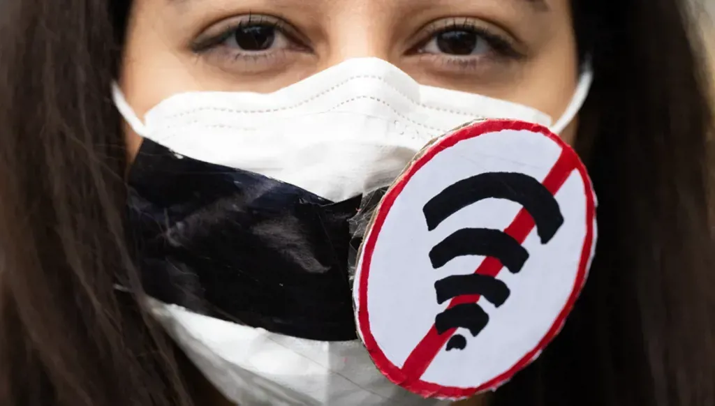 A protester wearing a mask bearing the Wi Fi symbol during a demonstration in Frankfurt in support of the Iranian opposition and against the internet shutdown in Iran.