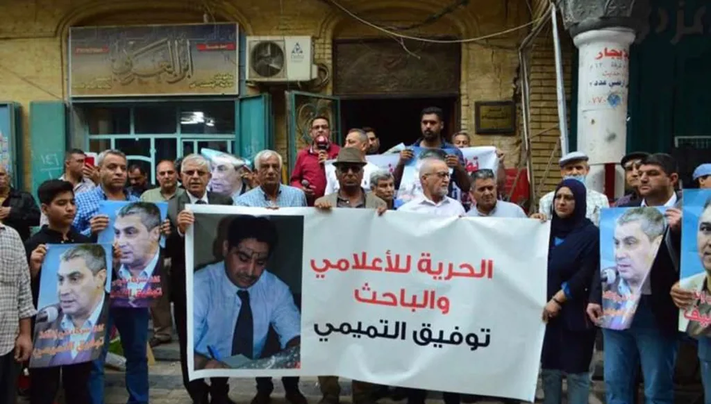 مشاركون في وقفة تضامنية يرفعون صور توفيق التميمي ولافتة تطالب بحريته والكشف عن مصيره. (أرشيف)