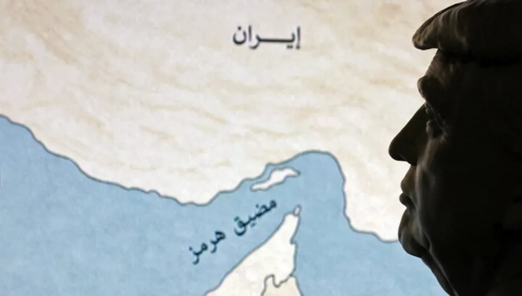 مجسم لوجه الرئيس الأميركي دونالد ترامب مع خريطة لمضيق هرمز (رويترز).