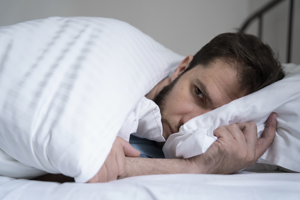 anxiousmanlayingbedmediumshot_134519.jpg
