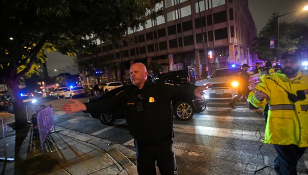 Law enforcement officials direct traffic outside the White House Correspondents Dinner, Saturday, April 25, 2026, in Washington. (AP Photo/Rod Lamkey, Jr.)