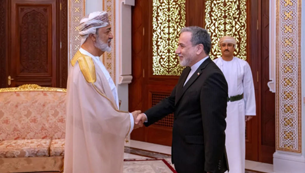 In this photo released by the Iranian Foreign Ministry, Iranian Foreign Minister Abbas Araghchi, right, shakes hands with Oman's Sultan Haitham bin Tariq during their meeting, in Muscat, Oman, Sunday, April 26, 2026. (Iranian Foreign Ministry via AP)