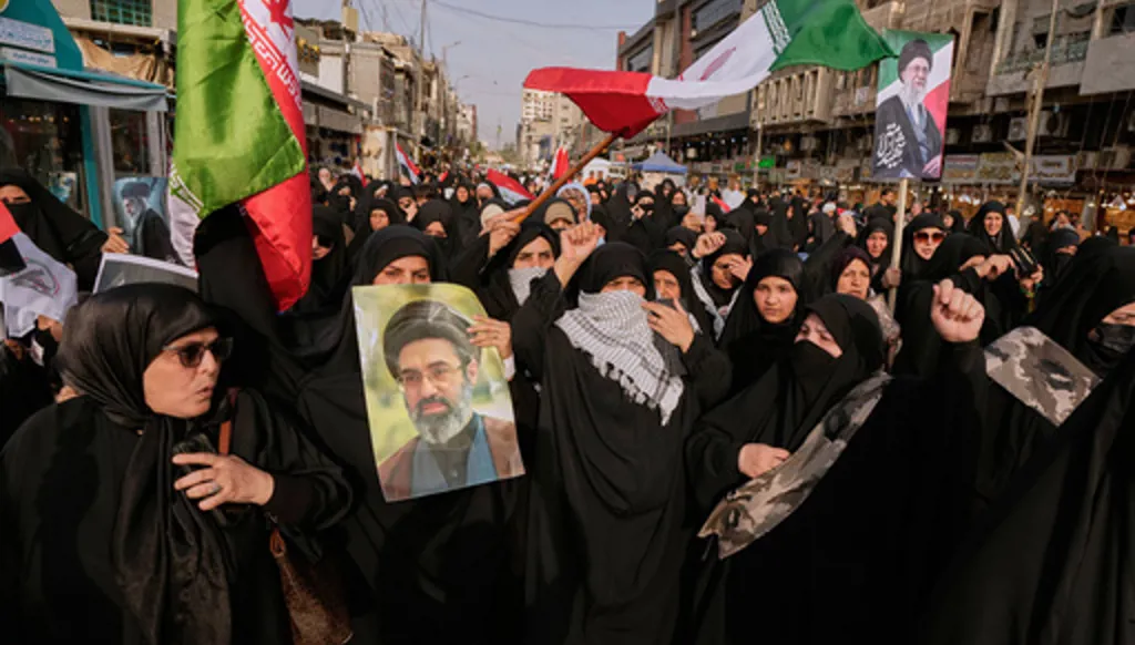 Iraqis Muslim women hold portraits of Iran's late Supreme Leader Ayatollah Ali Khamenei and his son Ayatollah Mojtaba Khamenei, during a protest against U.S. and Israeli attacks on multiple cities across Iran, in Baghdad, Iraq, Saturday, April 25, 2026. (AP Photo/Hadi Mizban)