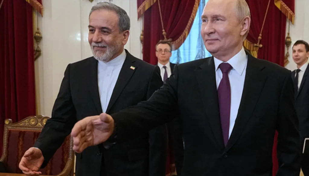 Russian President Vladimir Putin, right, and Iranian Foreign Minister Abbas Araghchi walk to attend the talks at the Boris Yeltsin Presidential Library, in St. Petersburg, Russia, Monday, April 27, 2026. (AP Photo/Dmitri Lovetsky, Pool)