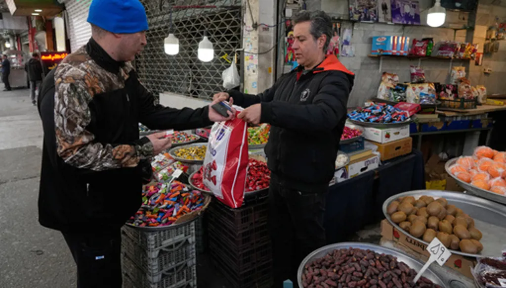 FILE - People conduct their businesses around the traditional grand bazaar of Tehran, Iran, March 29, 2026. (AP Photo/Vahid Salemi, File)