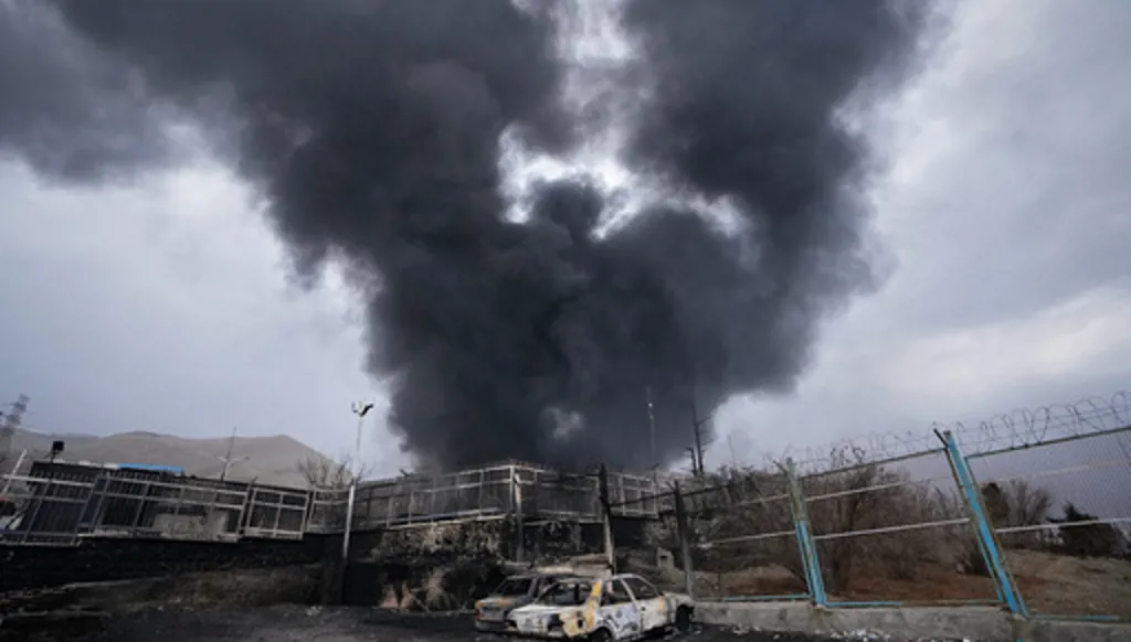 FILE - A thick plume of smoke rises from an oil storage facility hit by a U.S.-Israeli strike in Tehran, Iran, March 8, 2026. (AP Photo/Vahid Salemi, File)
