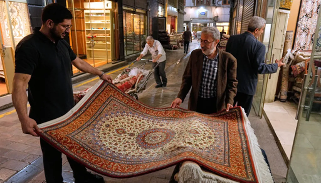People view rugs at the Grand Bazaar in Tehran, Sunday, May 3, 2026. (AP Photo/Vahid Salemi)