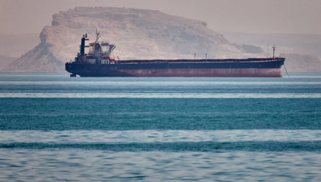 A bulk cargo ship sits at anchor in the Strait of Hormuz off Bandar Abbas, Iran, Saturday, May 2, 2026.(Amirhosein Khorgooi/ISNA via AP)