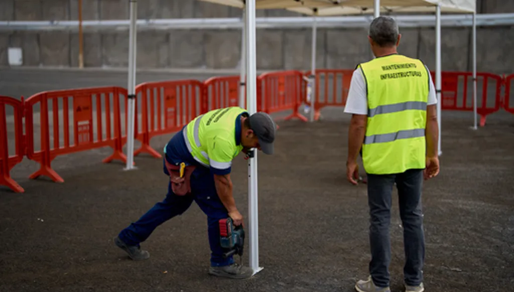 Workers set up temporary shelters in the area where passengers from the MV Hondius cruise ship are expected to arrive at the port of Granadilla in Tenerife, Canary Islands, Spain, Saturday, May 9, 2026. (AP Photo/Manu Fernandez)