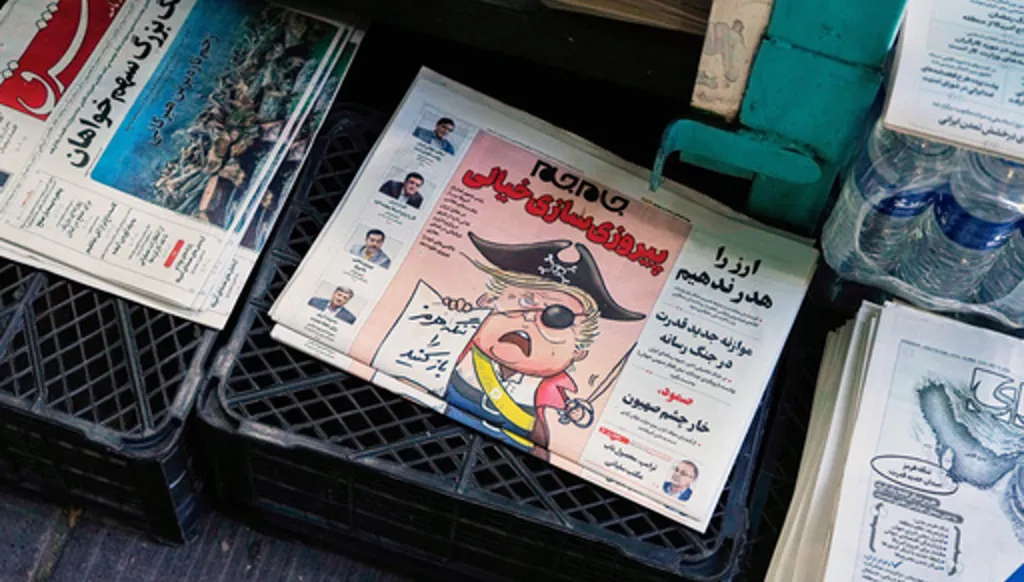 The front page of the Sunday May 10, 2026, edition of Iranian newspaper, Jamejam, is seen with a cartoon satirizing the U.S. President Donald Trump that asks: "Open the the Strait of Hormuz" on a news stand in northern Tehran, Iran, Sunday, May 10, 2026. (AP Photo/Vahid Salemi)