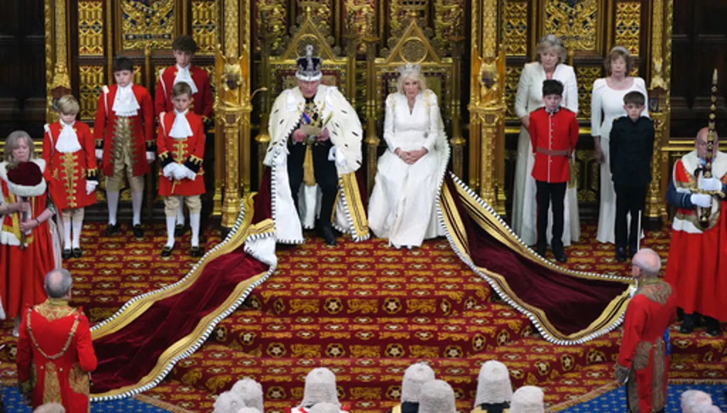 Britain's King Charles III reads out as he sits besides Queen Camilla during the State Opening of Parliament at the Palace of Westminster in London, Wednesday, May 13, 2026.(AP Photo/Kirsty Wigglesworth, Pool)