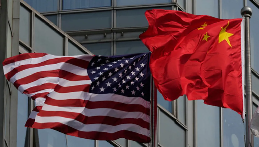 The United States and Chinese flags are flown outside a hotel expected to be used for U.S. President Donald Trump's visit to Beijing Wednesday, May 13, 2026. (AP Photo/Ng Han Guan)