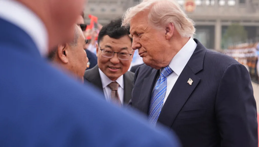 President Donald Trump interacts with China's Foreign Minister Wang Yi before boarding Air Force One, Friday, May 15, 2026, at Beijing Capital International Airport in Beijing. (AP Photo/Mark Schiefelbein)