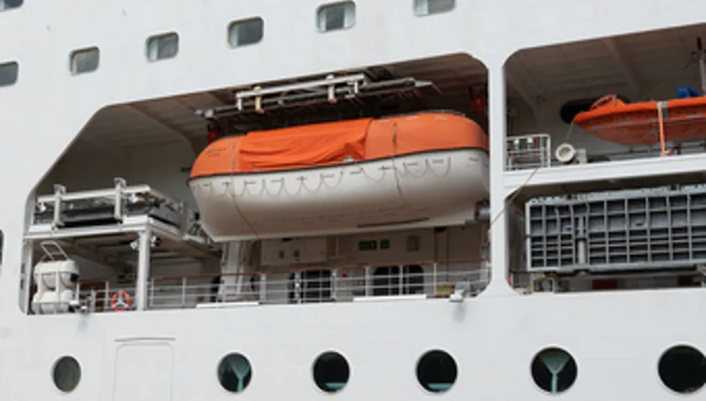 A barrier is set in front of the British cruise ship Ambition, as French authorities have ordered 1,700 passengers and crew to stay on board due to a gastrointestinal illness outbreak, in Bordeaux, southwestern France, Wednesday, May 13, 2026. (AP Photo/Caroline Blumberg)