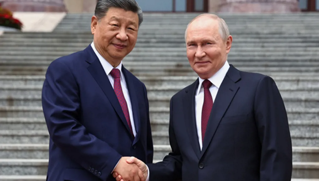 Russian President Vladimir Putin, right, and Chinese President Xi Jinping shake hands during a welcome ceremony at the Great Hall of the People, in Beijing, China, on Wednesday, May 20, 2026. (Alexander Kazakov, Sputnik, Kremlin Pool Photo via AP)