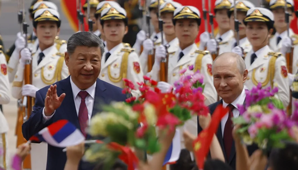 Russian President Vladimir Putin, right, and Chinese President Xi Jinping attend a welcoming ceremony at the Great Hall of the People in Beijing Wednesday, May 20, 2026. (Maxim Shemetov/Pool Photo via AP)