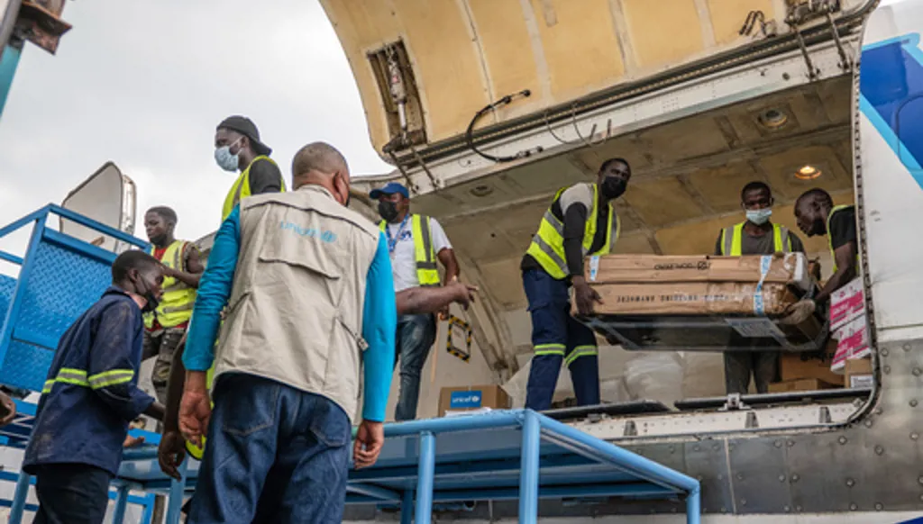 People offload a shipment of more than 15 tons of supplies donated by UNICEF as part of the response to the Ebola virus outbreak at Bunia National Airport in Bunia, Congo, Tuesday, May 19, 2026. (AP Photo/Moses Sawasawa)