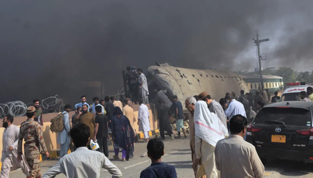 Paramilitary soldiers and volunteers recover victims from an overturned train coach on a railway track at the site of bomb explosion, in Quetta, Pakistan, Sunday, May 24, 2026. (AP Photo/Arshad Butt)