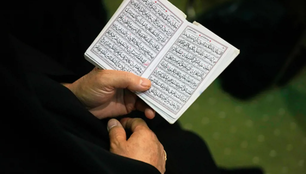 A woman reads passages from Islam's holy book, the Quran, during a ceremony honoring the armed forces and those killed in the war with Israel and the U.S. at the Imam Khomeini Grand Mosque in Tehran, Iran, Sunday, May 24, 2026. (AP Photo/Vahid Salemi)
