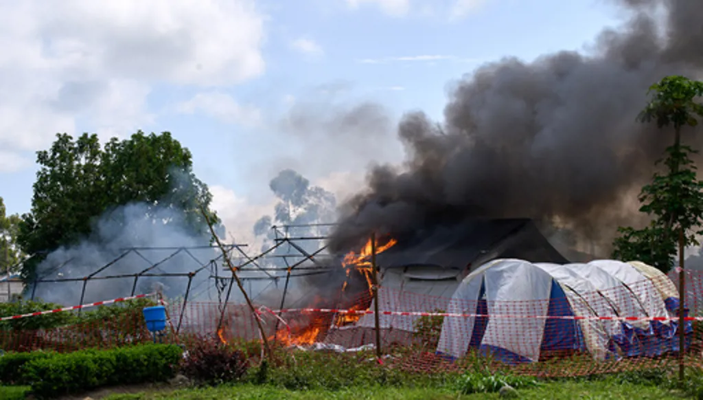 Flames and smoke rise from an Ebola treatment center in Rwampara, Congo, Thursday, May 21, 2026. (AP Photo/Dirole Lotsima Dieudonne)