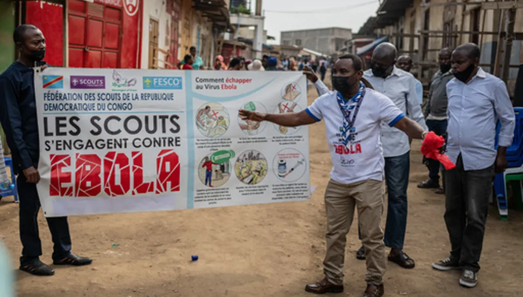 Members of the Congo Scouts movement carry an Ebola awareness banner along a street during a public sensitisation campaign amid the Ebola outbreak in Bunia, Congo, Saturday, May 23, 2026. (AP Photo/Moses Sawasawa)