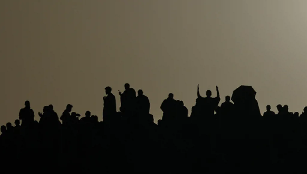 Muslim pilgrims are silhouetted as they pray at top of the rocky hill known as the Mountain of Mercy, on the Plain of Arafat, during the annual Hajj pilgrimage near the holy city of Mecca, Saudi Arabia, Tuesday, May 26, 2026. (AP Photo/Altaf Qadri)