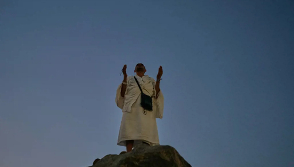 A Muslim pilgrim pray atop of the rocky hill known as the Mountain of Mercy, on the Plain of Arafat, during the annual Hajj pilgrimage near the holy city of Mecca, Saudi Arabia, Tuesday, May 26, 2026. (AP Photo/Altaf Qadri)