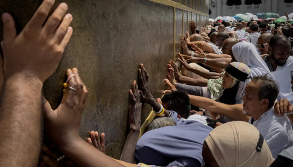 Muslim pilgrims touch the walls of the Kaaba, the cubic building at the Grand Mosque, during the annual Hajj pilgrimage, in Mecca, Saudi Arabia, Thursday, May 21, 2026. (AP Photo/Altaf Qadri)