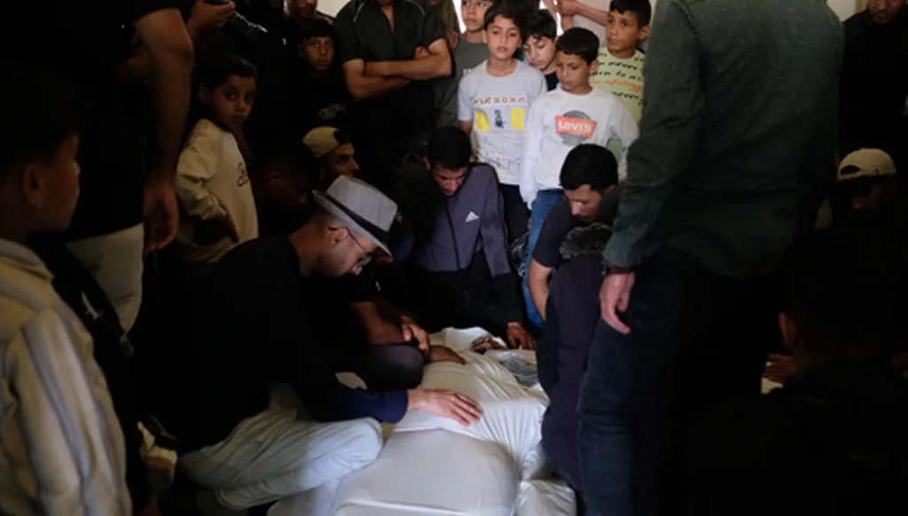 Palestinians mourn over the body of Mohammad Odeh, whom Israel says was a leader of Hamas Qassam Brigades, a day after he was killed in an Israeli airstrike, during his funeral in Gaza City, Wednesday, May 27, 2026. (AP Photo/Jehad Alshrafi)