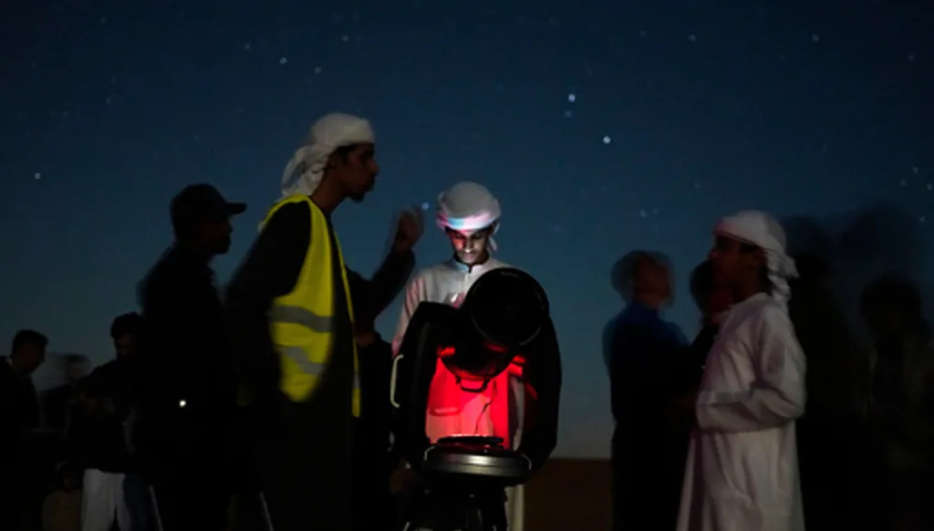 This long-exposure photograph shows Emiratis gathered around a telescope in the Al Quaa Desert outside of Abu Dhabi, United Arab Emirates, Saturday, May 23, 2026. (AP Photo/Jon Gambrell)