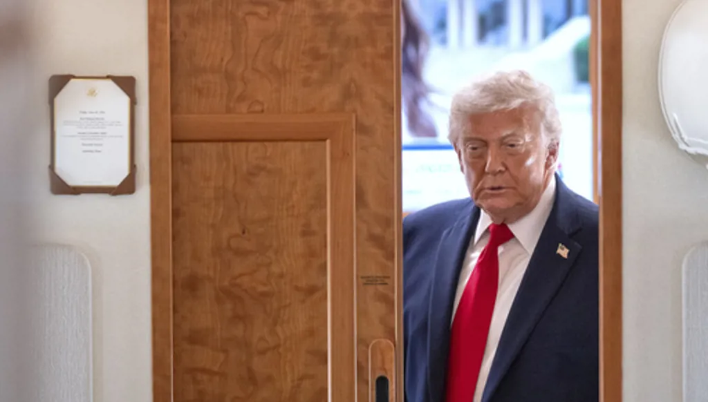 President Donald Trump arrives to speak to reporters aboard Air Force One en route from Joint Base Andrews, Md., to Eau Claire, Wis., Friday, June 5, 2026. (AP Photo/Mark Schiefelbein)
